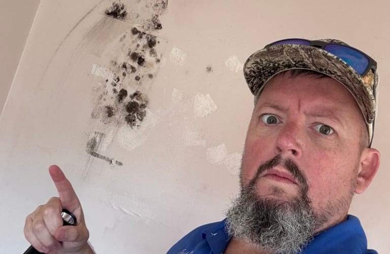 Inspector collecting mold air sample indoors